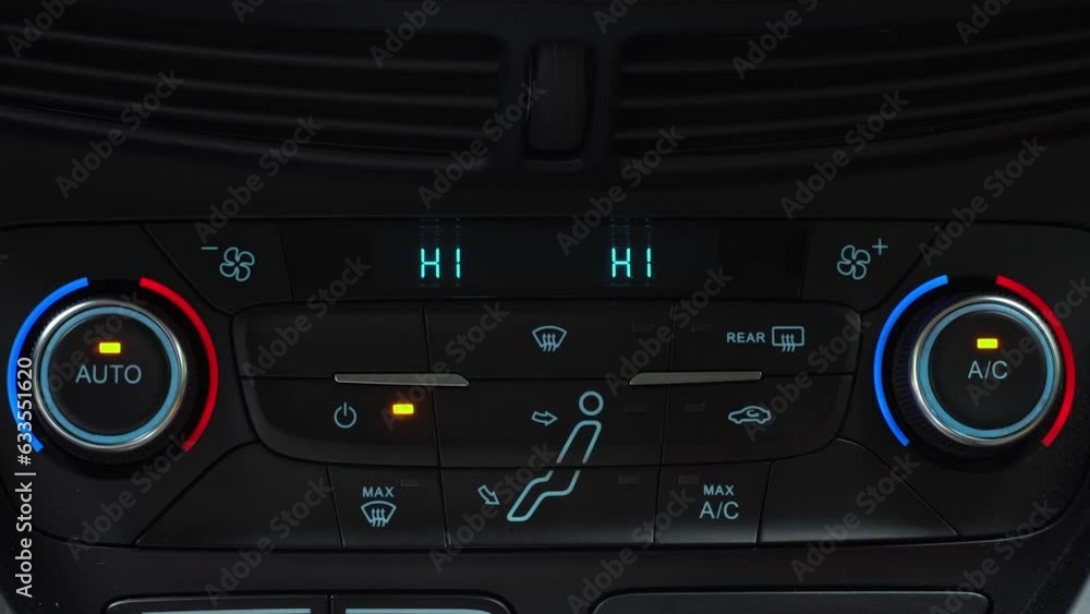 Finger turning on climate control toggle switch of car air conditioner, auto climate control in the car Finger turning on climate control toggle switch of car air conditioner, auto climate control in the car