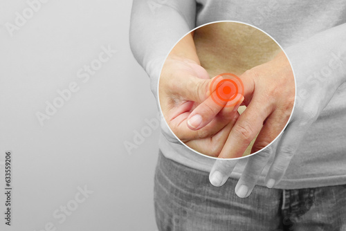 Woman touching her knuckle for the pain with red inflammation effect. Healthcare and office syndrome concept. photo