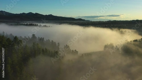 Fog settles over a lake nestled into the Black Hills of South Dakota