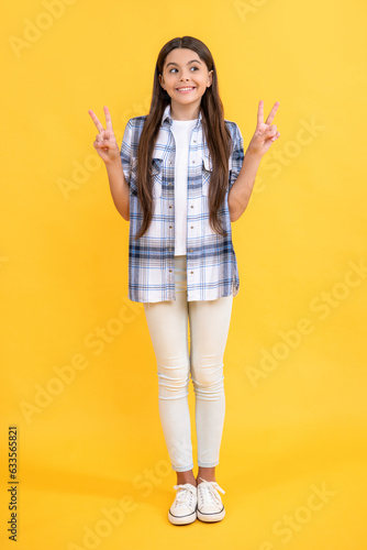 young and trendy. gen z. stylish shirt for everyday life. peace. stylish teenager girl. teen girl wearing checkered shirt. casual style of teenager girl. teen girl having long hair © be free