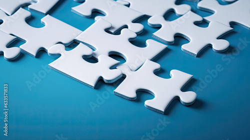 White jigsaw puzzle pieces on a blue background in business teamwork concept