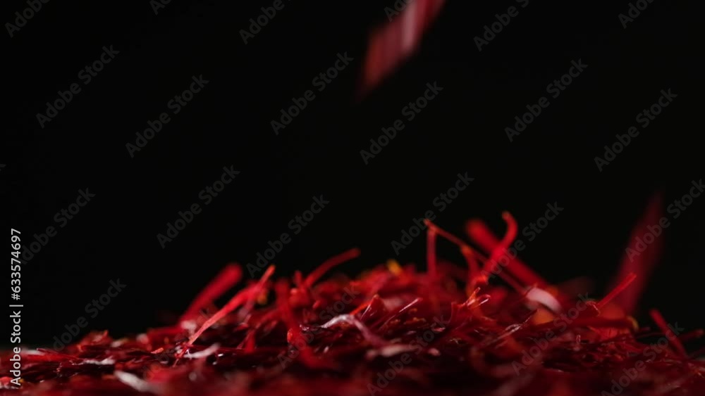 Saffron threads spice are falling down a pile of many Saffron threads. Saffron (Crocus sativus) may provide pain relief