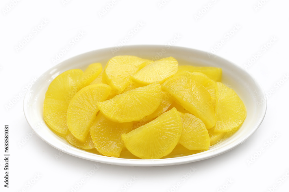 Sweet and tart slices of yellow pickled daikon, known as takuan in Japan and danmuji in Korea. Sweet and tart slices of yellow pickled daikon, known as takuan in Japan and danmuji in Korea.