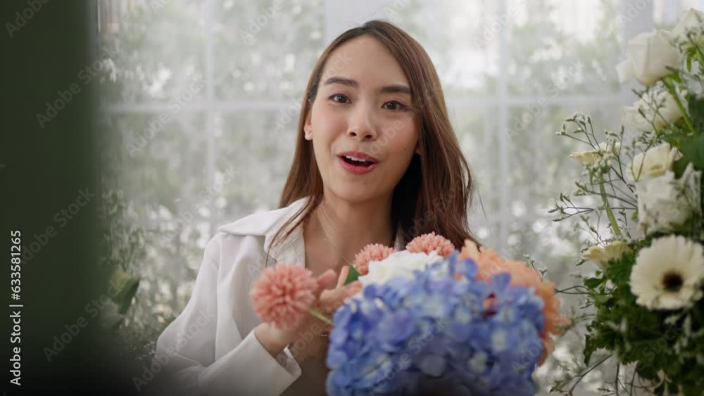 Beauty lady blogger florist and Vlog make content concept.Young florist female routine tutorial at camera on tripod at workplace.Influencer artist woman live streaming in flower shop studio at home. Beauty lady blogger florist and Vlog make content concept.Young florist female routine tutorial at camera on tripod at workplace.Influencer artist woman live streaming in flower shop studio at home.
