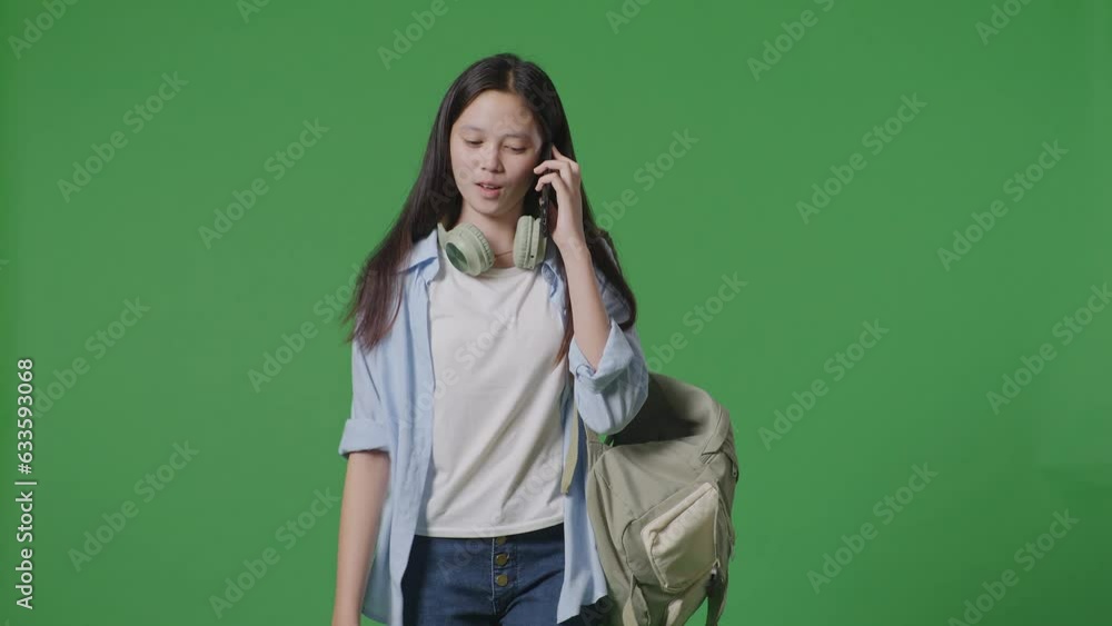 Asian Teen Girl Student With A Backpack Talking On Smartphone While Walking In The Green Screen Background Studio
Asian Teen Girl Student With A Backpack Talking On Smartphone While Walking In The Green Screen Background Studio