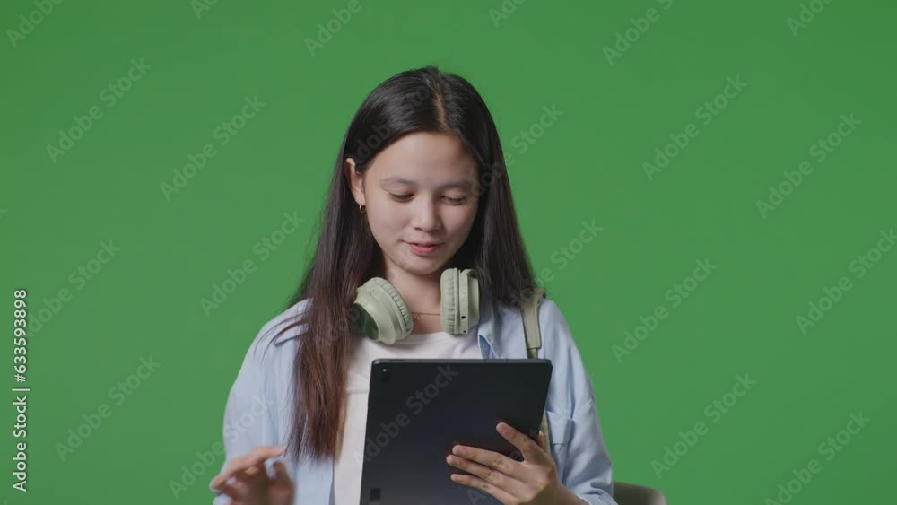 Close Up Of Asian Teen Girl Student With A Backpack Smiling And Using A Tablet While Walking In The Green Screen Background Studio
Close Up Of Asian Teen Girl Student With A Backpack Smiling And Using A Tablet While Walking In The Green Screen Background Studio