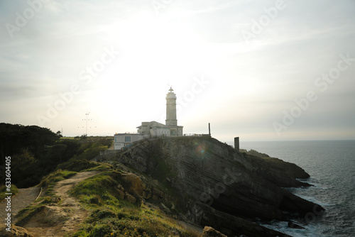 Lighthouse on top of a cliff by the sea. Santander, Cantabria, Spain photo