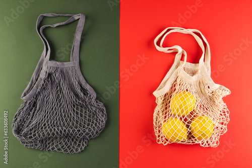 Brown and white mesh net bags with lemons and copy space on red and dark green background