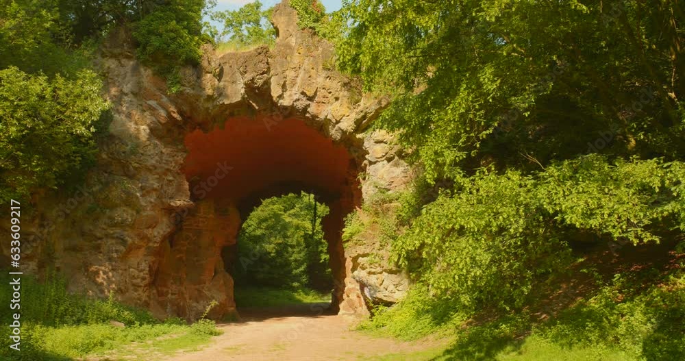Famous Rock Bridge With Green Foliage At Bois de la Cambre Park In Brussels, Belgium. pan left Famous Rock Bridge With Green Foliage At Bois de la Cambre Park In Brussels, Belgium. pan left
