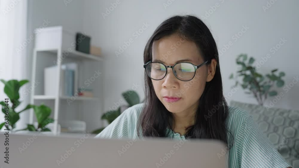 Portrait. Asian woman using laptop, typing work with computer at home morning Portrait. Asian woman using laptop, typing work with computer at home morning