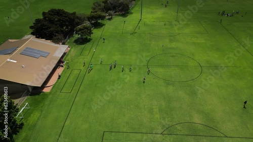 Soccer players entering Perth city field in Australia for amateur football match. Aerial drone circling view photo