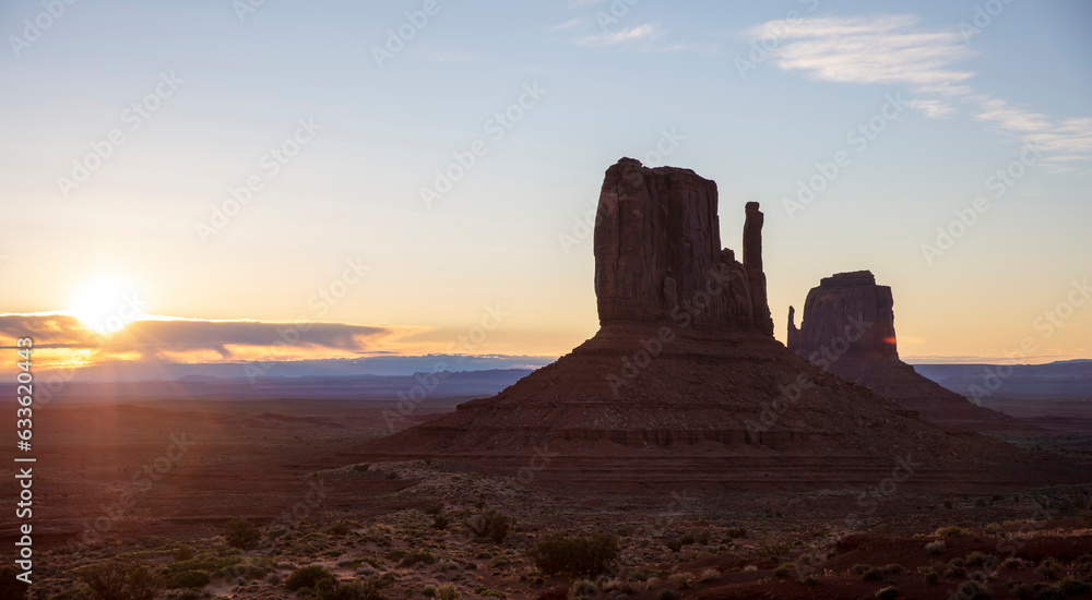Sunset over Monument Valley, sunbeam, blue sky. Navajo Tribal Park, USA, Utah, Arizona. Copy space