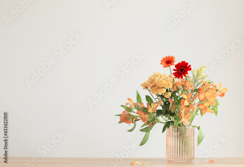 autumn bouquet on wooden shelf on background gray wall