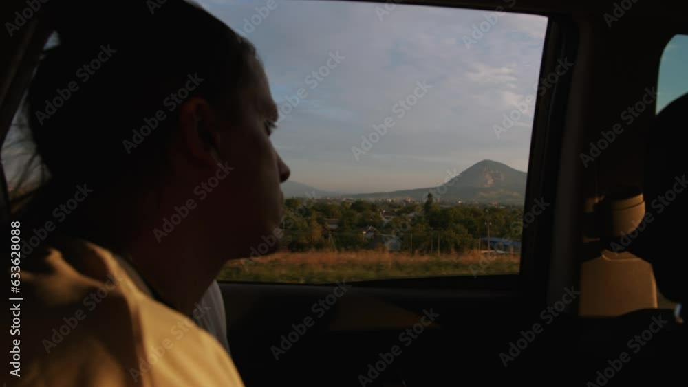 custom made wallpaper toronto digitalMan on passenger seat of car against backdrop of row of mountains. Slow motion