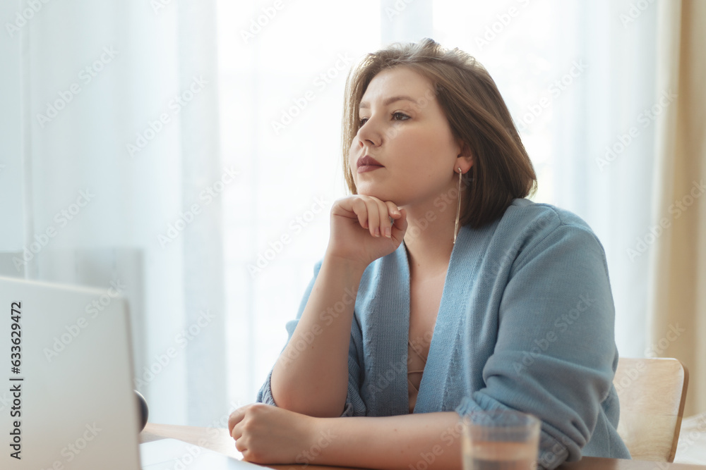 Plus size woman thinking and having break while working at home. Distance remote work concept. Plus size woman thinking and having break while working at home. Distance remote work concept.