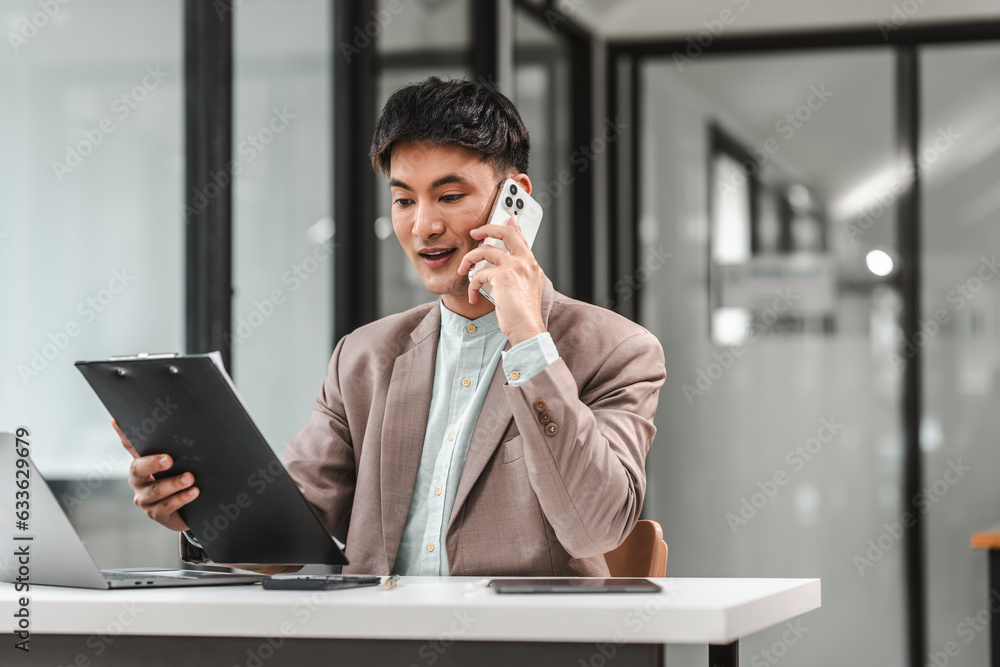 Call with clients, Asian business asian man supervisor analyse financial report of responsible worker pay attention on mistakes propose correction. Call with clients, Asian business asian man supervisor analyse financial report of responsible worker pay attention on mistakes propose correction.
