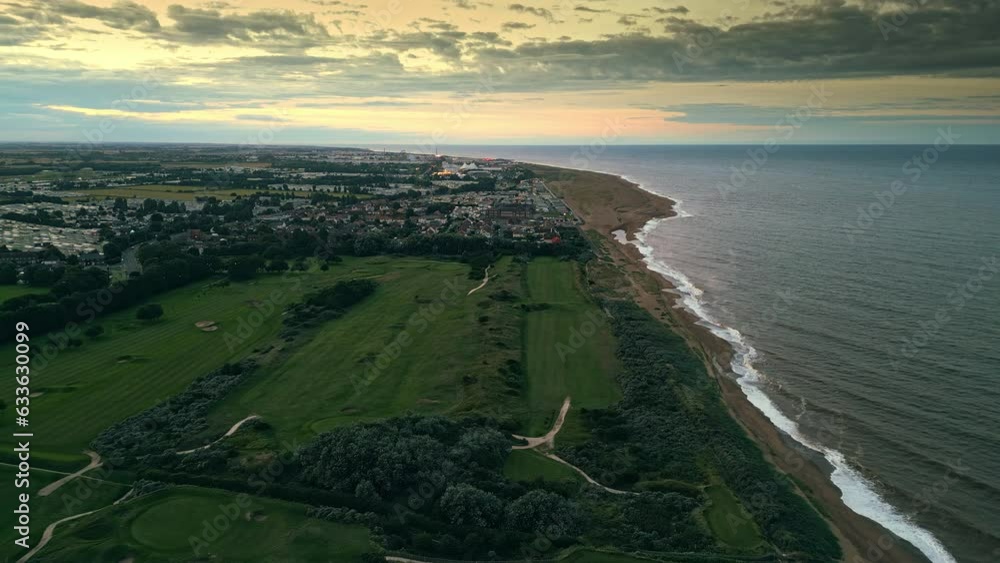 Explore Skegness through aerial drone video at sunset, featuring holiday park, caravans, sea, and wide beach. Explore Skegness through aerial drone video at sunset, featuring holiday park, caravans, sea, and wide beach.