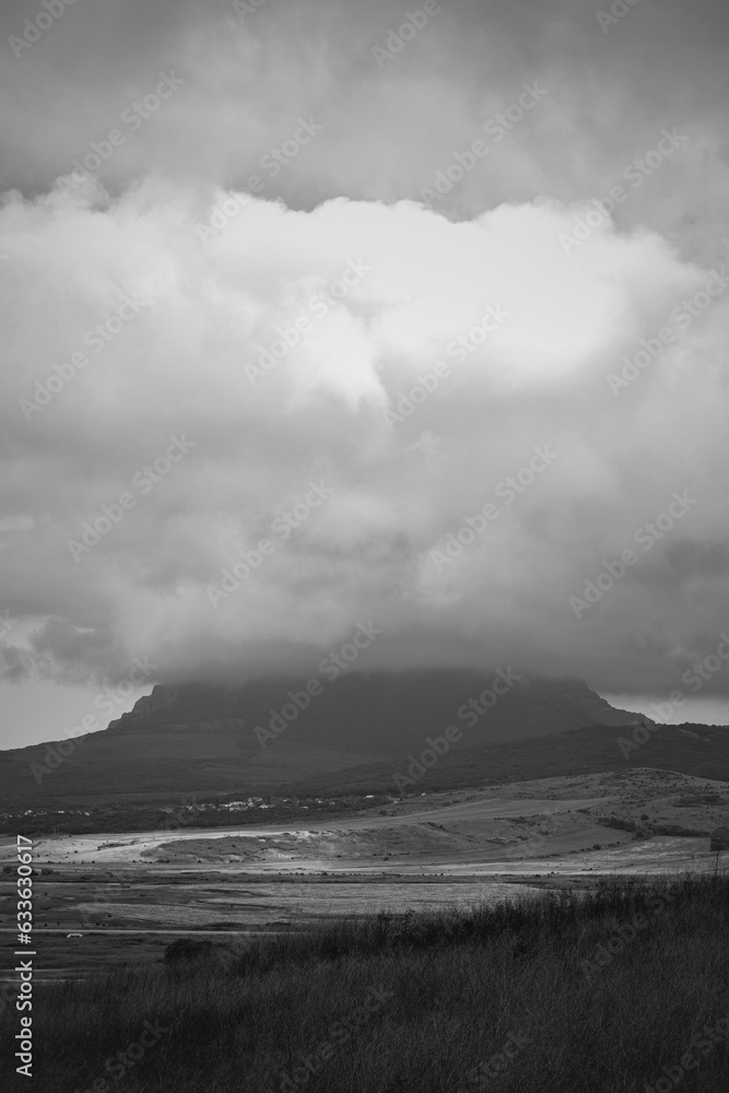 Storm clouds over the mountains area in black and white 