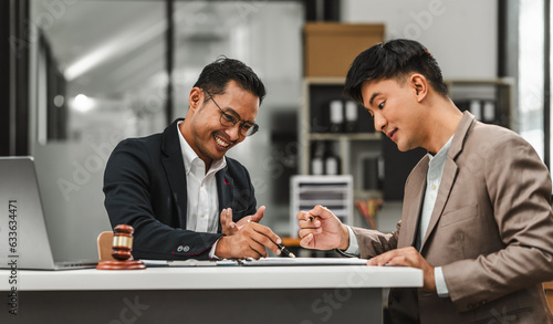 Fotografia Two disgusting businessmen Asian lawyer of Indian descent paying attention to mistakes, proposing corrections