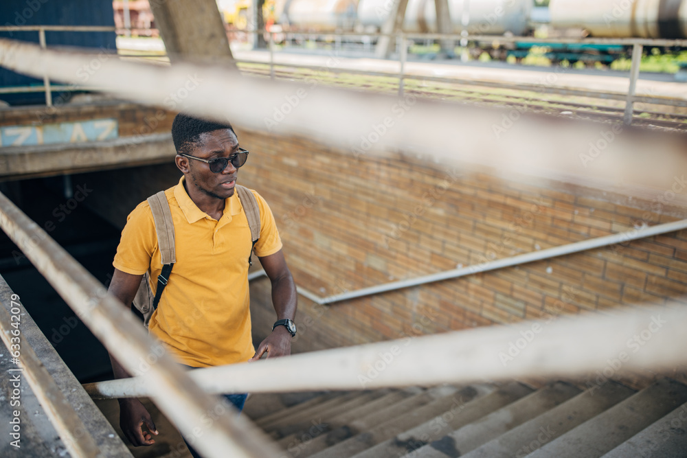 Young man with headphones and mobile phone on the train station