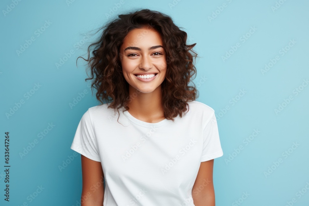 Woman posing with arms crossed on blue background Woman posing with arms crossed on blue background