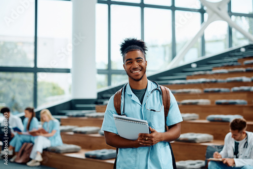 Fotografie Happy black medical student in amphitheater looking at camera.