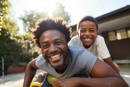 Happy African Black father having fun with teen boy at home.