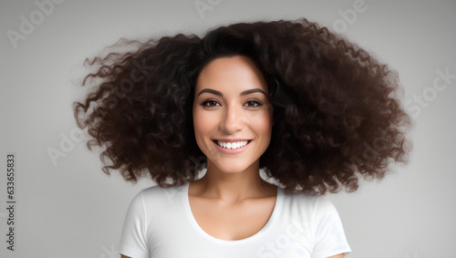 Portrait of beautiful woman with black  curly hair smiling at camera on natural background with copy space. Generative AI.