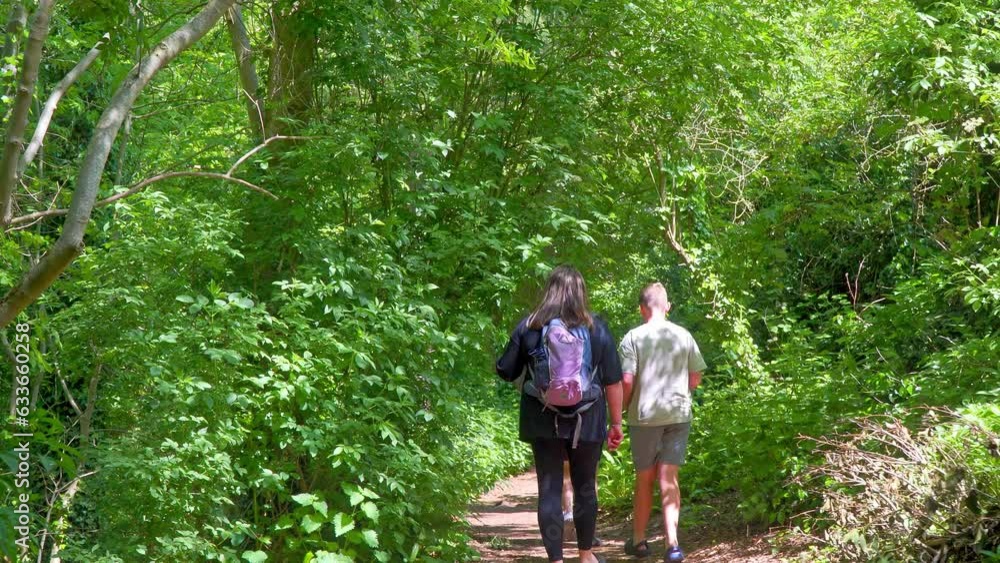 People explore a British summer park, delighting in a winding stream, delightful picnic spots, and a wooded tourist site—Hubbard's Hills. People explore a British summer park, delighting in a winding stream, delightful picnic spots, and a wooded tourist site—Hubbard's Hills.