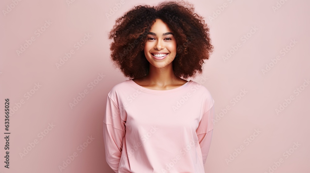 Beautiful young black woman posing on a light pink studio background with room for text Beautiful young black woman posing on a light pink studio background with room for text