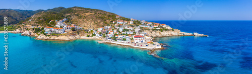 Lovely greek fishing village of Armenistis in a quiet summer morning. Port with local beach in transparent clear water at Ikaria, Greece © gatsi