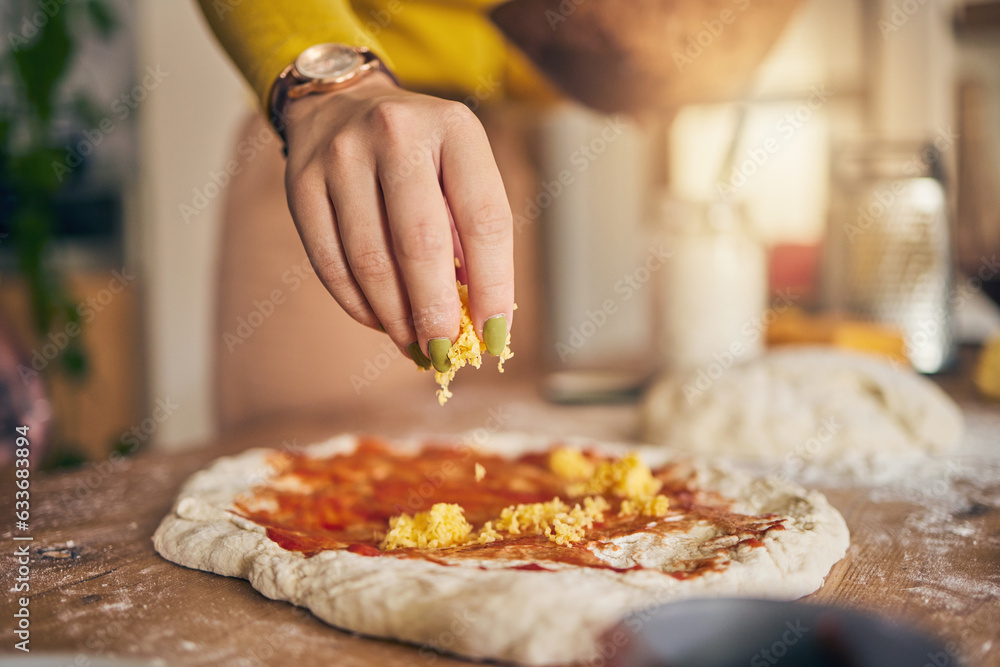 Hand, cheese and pizza for cooking, closeup and ready for food, restaurant or fast food with skill in Naples. Chef woman, dough and tomato sauce for cuisine, culture and preparation with process
