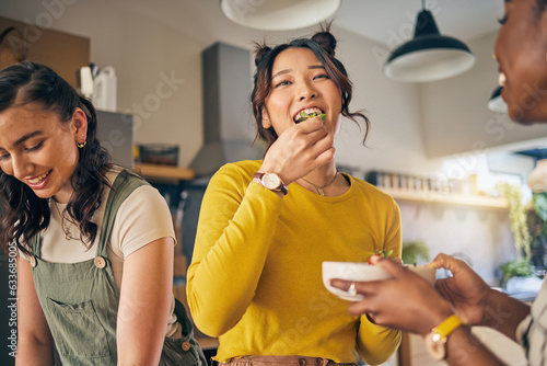 Women, friends and eating healthy food in home for bonding, nutrition and happy lunch together. Fruit diet, sharing and wellness, fresh summer friendship and girls in kitchen with smile at party.