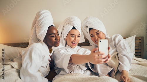 Spa day, selfie and friends in bed relax with social media during skincare routine at home. Bedroom, self care and women beauty influencer with smartphone smile for profile picture, blog or podcast