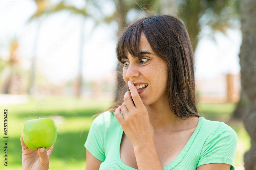 Young woman with an apple at outdoors with surprise and shocked facial expression Young woman with an apple at outdoors with surprise and shocked facial expression