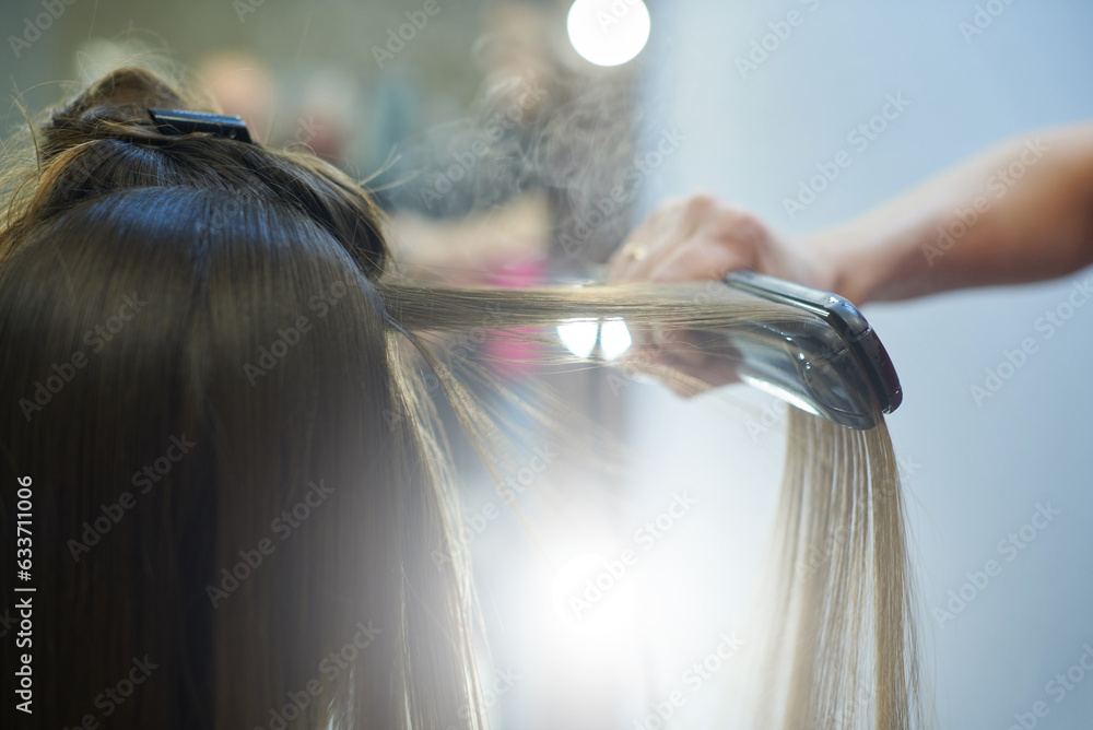 Hair straightening with keratin and a hair iron - obrazy, fototapety, plakaty 