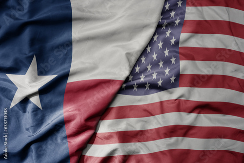 big waving colorful national flag of united states of america and flag of texas state .