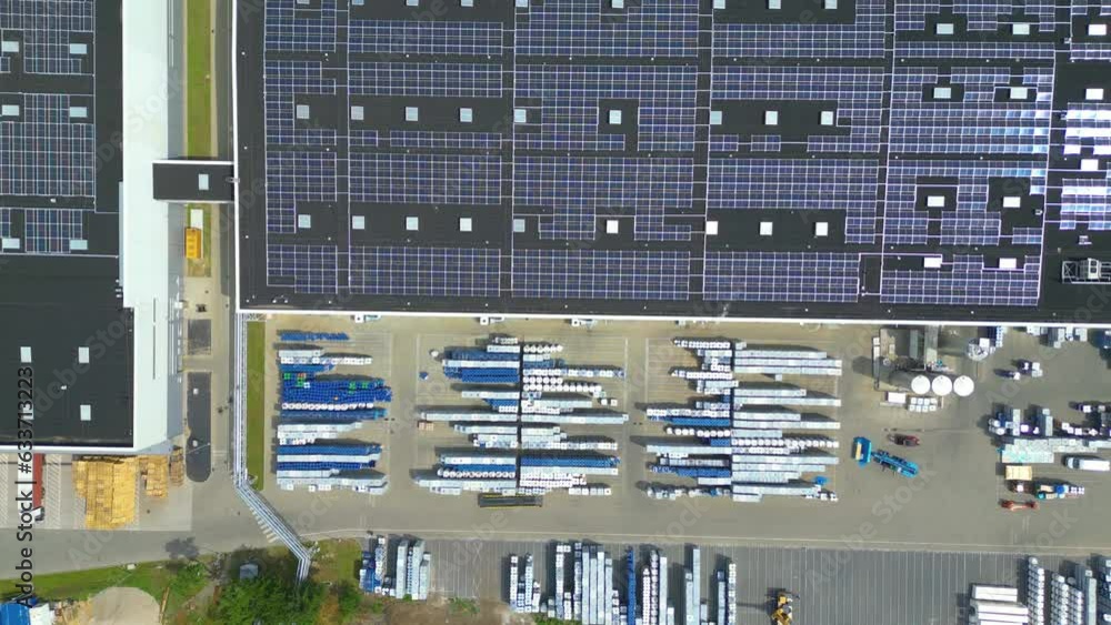 Aerial view of modern storage warehouse with solar panels on the roof. Logistics center in industrial city zone from drone view. Background texture concept. Aerial view of modern storage warehouse with solar panels on the roof. Logistics center in industrial city zone from drone view. Background texture concept.