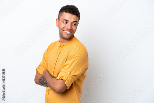 Young caucasian Brazilian man isolated on white background looking to the side and smiling