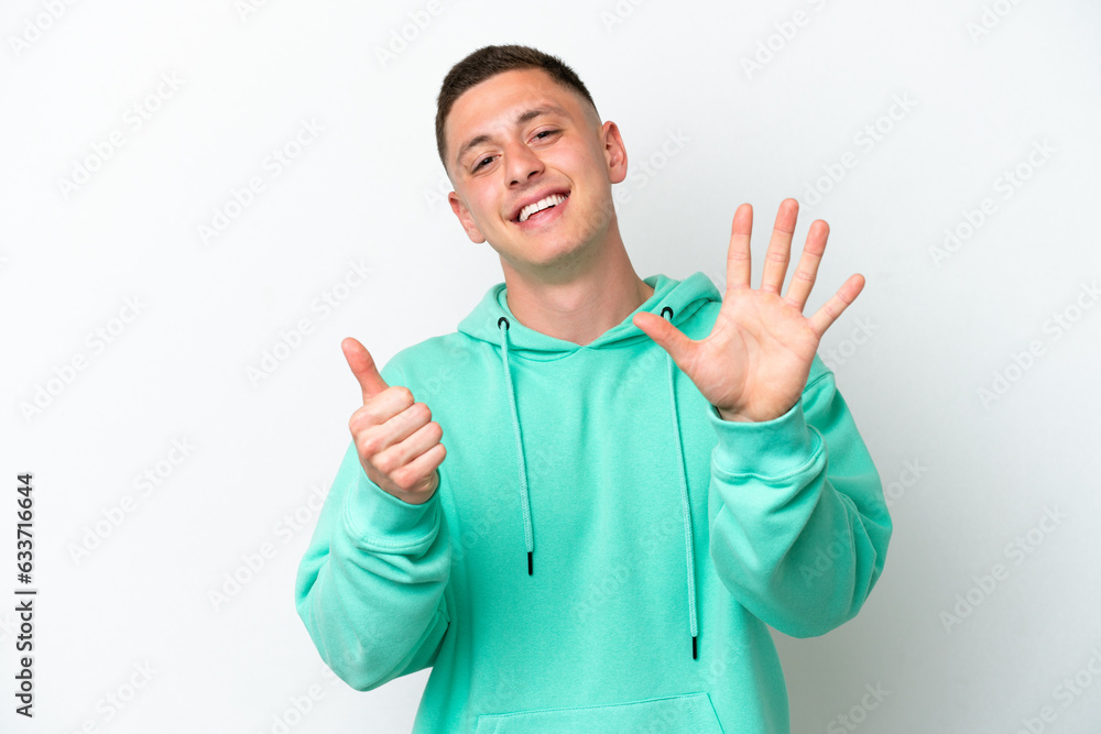 Young brazilian man isolated on white background counting six with fingers Young brazilian man isolated on white background counting six with fingers