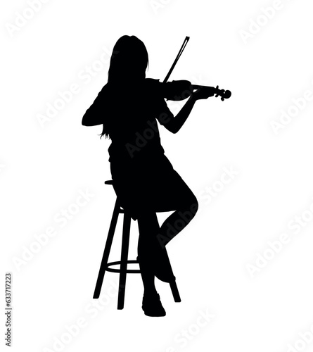 Little girl playing volin while sitting on chair silhouette. photo