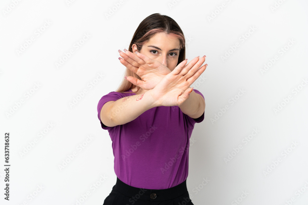 Young caucasian woman isolated on white background making stop gesture with her hand to stop an act Young caucasian woman isolated on white background making stop gesture with her hand to stop an act