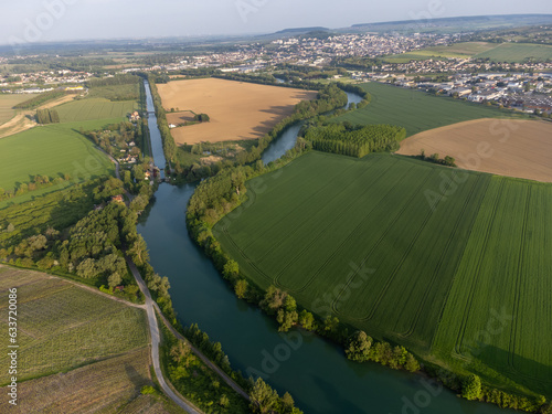 Panoramic aerial view on green premier cru champagne vineyards and fields near village Hautvillers and Cumieres and Marne river valley, Champange, France © barmalini