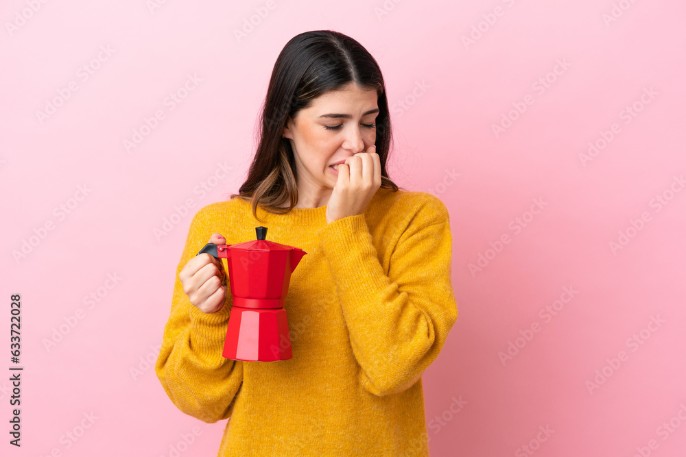 Young Italian woman holding a coffee maker isolated on pink background having doubts Young Italian woman holding a coffee maker isolated on pink background having doubts