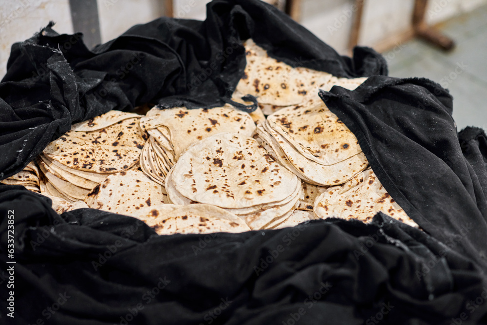 Batch of chapati round flatbreads in black bag for langar in sikh