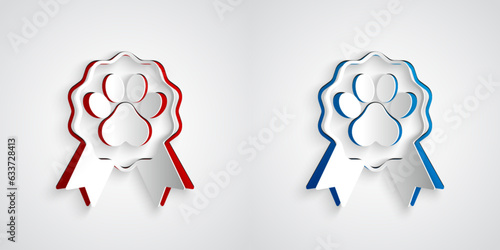 Paper cut Pet award symbol icon isolated on grey background. Badge with dog or cat paw print and ribbons. Medal for animal. Paper art style. Vector