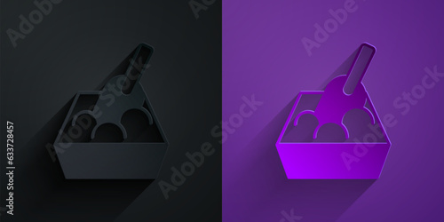 Paper cut Cat litter tray with shovel icon isolated on black on purple background. Sandbox cat with shovel. Paper art style. Vector