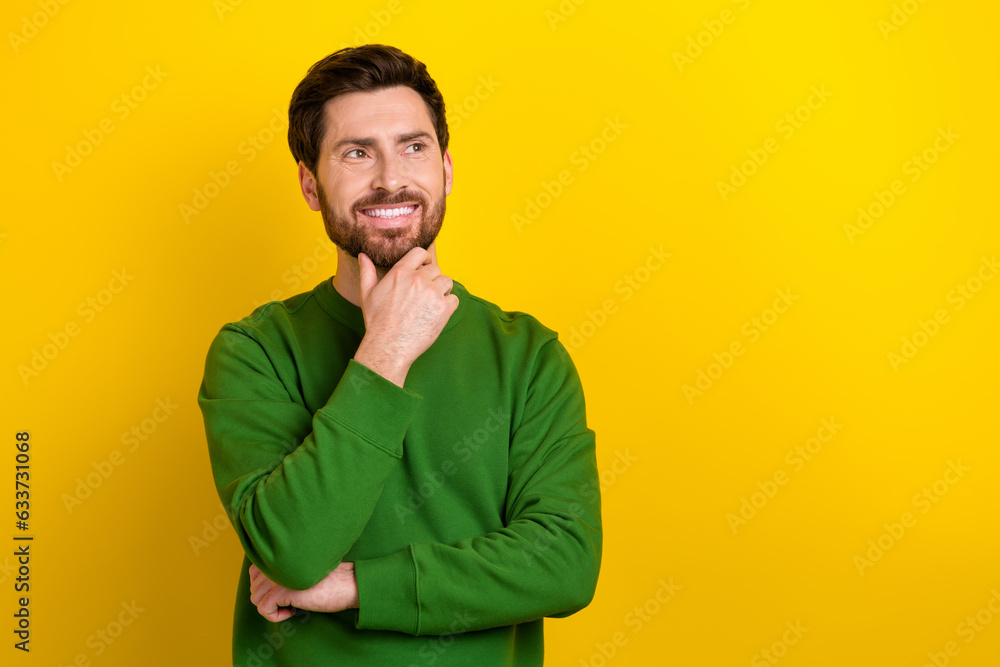 Portrait of young businessman touch beard looking thoughtful empty space find creative solution problem isolated on yellow color background Portrait of young businessman touch beard looking thoughtful empty space find creative solution problem isolated on yellow color background