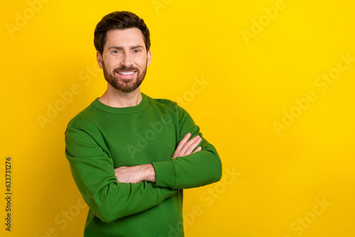 Portrait of attractive guy experienced worker hold folded arms demonstrating empty space ad adv isolated yellow color background