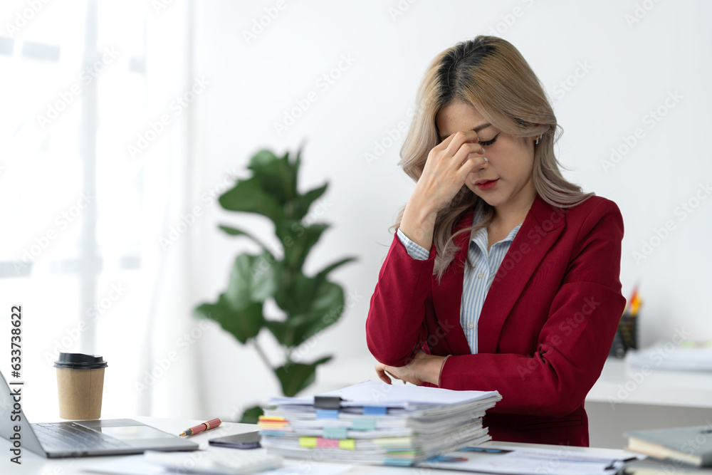 tired business woman sleepy and bored from sitting at a desk for a long time and has office syndrome